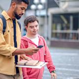 Staff member helping a participant with a daily task